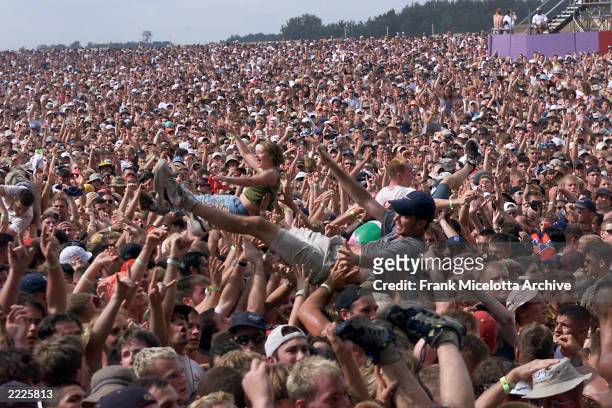 Fans at Woodstock 99 in Rome, New York. The Woodstock 99 festival will feature over 45 bands on four stages on July 23 and 25th. Crowd estimate for...