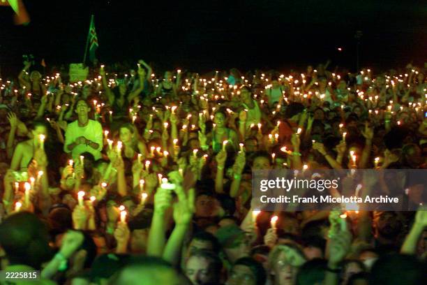 Fans burn candles at Woodstock 99 in Rome, New York. The Woodstock 99 festival will feature over 45 bands on four stages on July 23 and 25th. Crowd...