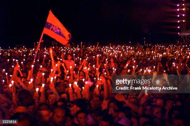 Fans burn candles at Woodstock 99 in Rome, New York. The Woodstock 99 festival will feature over 45 bands on four stages on July 23 and 25th. Crowd...