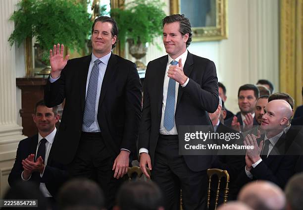 Investors Tyler and Cameron Winklevoss attend the signing ceremony for the “GENIUS Act” in the East Room of the White House July 18, 2025 in...