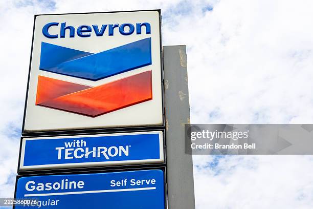 The Chevron logo is seen at a gas station on July 18, 2025 in Austin, Texas. Chevron has completed its $53 billion acquisition of Hess after a tense...