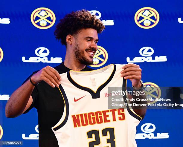 Newly acquired Denver Nuggets basketball player, Cam, Johnson holds his jersey during his introductory press conference at Ball Arena in Denver,...