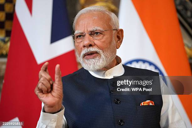 Prime Minister Narendra Modi of India gestures during a press conference with Britain's Prime Minister Keir Starmer after signing a free trade...