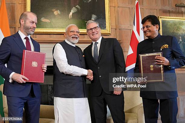 Britain's Prime Minister Keir Starmer and Prime Minister Narendra Modi of India shake hands after Britain's Secretary of State for Business and...