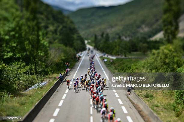 This photograph taken with a tilt-shift lens shows the pack of riders cycling during the 18th stage of the 112th edition of the Tour de France...