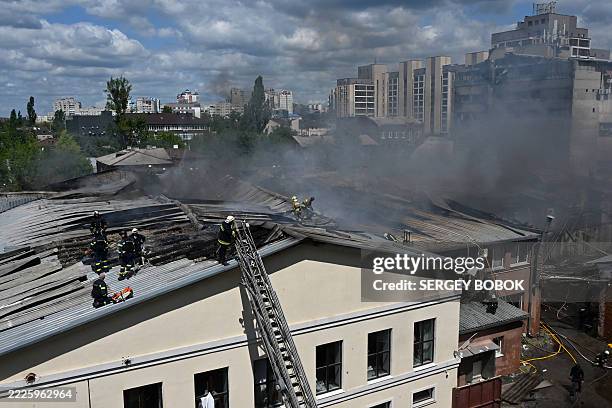 Ukrainian rescuers work to extinguish a fire at the site of an aerial attack in Kharkiv on July 24 amid the Russian invasion in Ukraine.