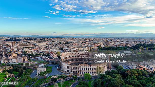 aerial view of the ancient colosseum in rome with panoramic cityscape, iconic roman amphitheater from different angles including top-down detail, historical architecture and tourism concept for editorial and travel design - romano imagens e fotografias de stock