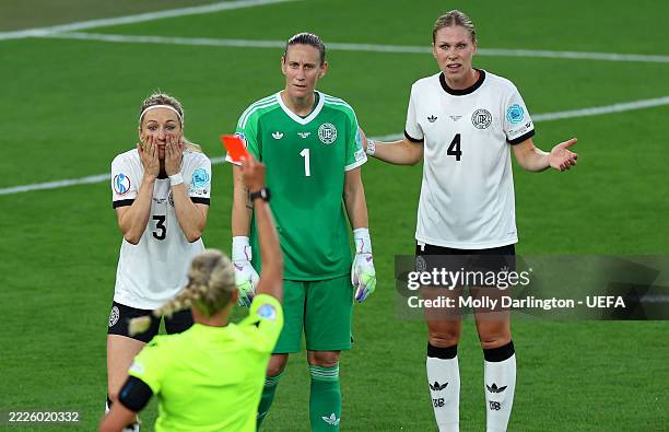 Kathrin Hendrich of Germany reacts, as she is shown a red card by Referee Tess Olofsson, as Ann-Katrin Berger and Rebecca Knaak of Germany look on...
