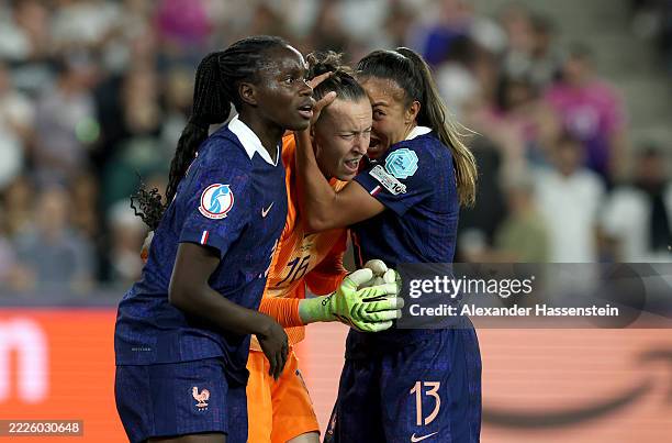 Pauline Peyraud-Magnin of France celebrates with team mates Griedge Mbock Bathy and Selma Bacha of France after saving a penalty taken by Sjoeke...