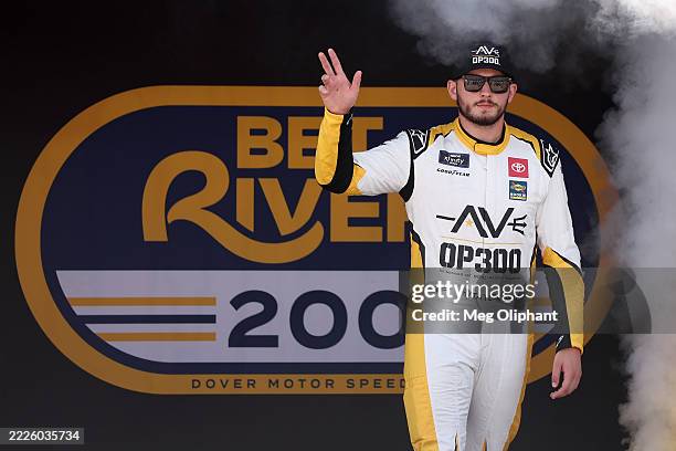 Taylor Gray, driver of the Operation 300 Toyota, waves to fans as he walks onstage during driver intros prior to the NASCAR Xfinity Series BetRivers...