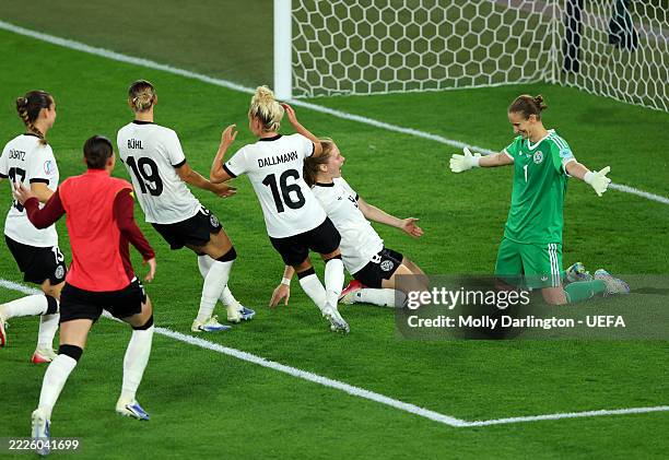 Ann-Katrin Berger of Germany celebrates with teammates after saving a penalty kick from Sakina Karchaoui of France, , winning the penalty shootout...