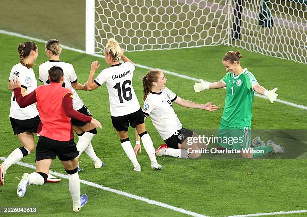 Ann-Katrin Berger of Germany celebrates with Sjoeke Nuesken and teammates, after saving a penalty kick from Alice Sombath of France, , winning the...