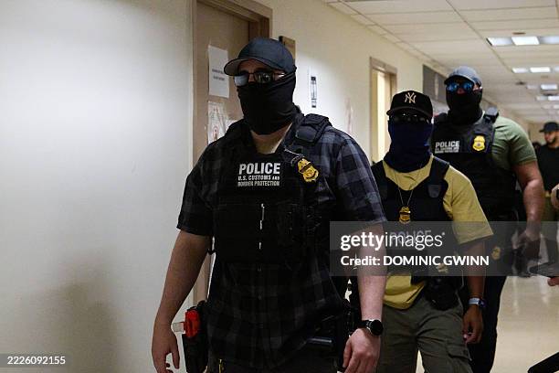 Federal agents working for Immigration and Customs Enforcement detain immigrants and asylum seekers reporting for immigration court proceedings at...