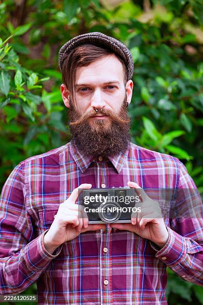 hipster holding a old camera - eccentric stock pictures, royalty-free photos & images