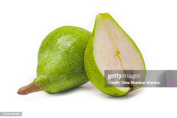 juicy halved green pear close-up on white - pera fotografías e imágenes de stock