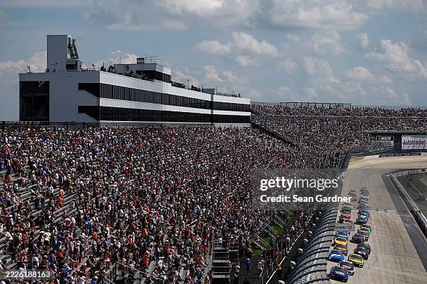 Chase Elliott, driver of the NAPA Auto Parts Chevrolet, leads the field during the NASCAR Cup Series AutoTrader EchoPark Automotive 400 at Dover...