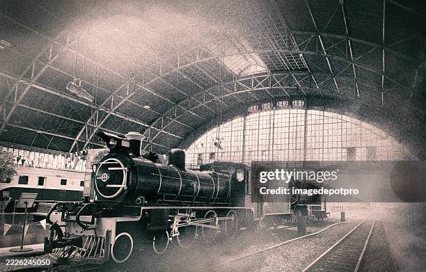 vintage style image of old steam train in railway station - history and progress of the steam engine stock pictures, royalty-free photos & images