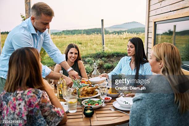friends enjoying outdoor meal in nature - city break stock pictures, royalty-free photos & images