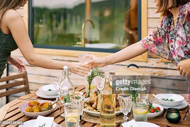 friends setting homemade lunch outdoors near camper van - outdoor dining stock pictures, royalty-free photos & images