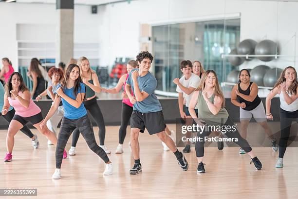 group of individuals enjoying a fitness dance class in a studio setting - aeróbica imagens e fotografias de stock