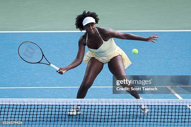 Venus Williams returns a shot during a women's doubles match with Hailey Baptiste against Eugenie Bouchard and Cleave Ngounoue on day 1 of the...
