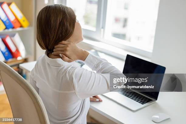 businesswoman experiencing neckache - hernia stock pictures, royalty-free photos & images