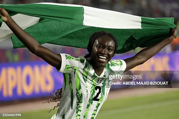 Nigeria's midfielder Rinsola Babajide celebrates with a national flag after winning the 2025 Women's Africa Cup of Nations final football match...