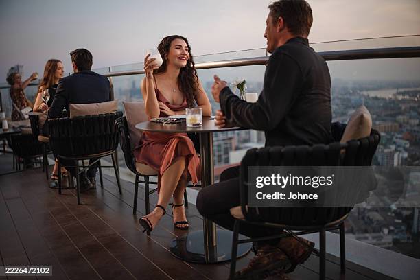 couple enjoying romantic rooftop dinner - överklass bildbanksfoton och bilder