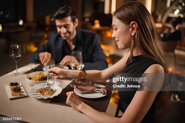 couple enjoying romantic dinner - exclusive dining stock pictures, royalty-free photos & images