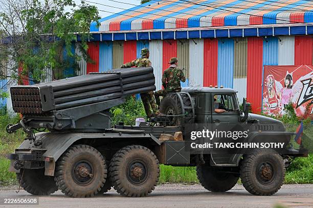 Cambodian soldiers tride a truck equipped with a Russian-made BM-21 rocket launcher in Cambodia's northern Oddar Meanchey province, which borders...