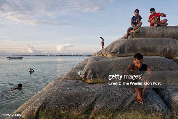 Kids play on sand bags used for land reclamation in Funafuti, Tuvalu on April 2, 2025. Tuvalu, a nation made of nine tiny islands in the South...
