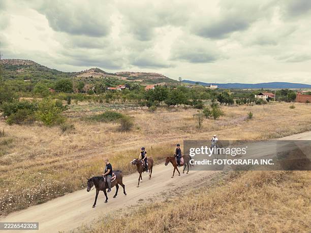 group of horse riders on the trail in rural landscape - cattle ranch pov stock pictures, royalty-free photos & images