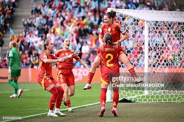 Spain's midfielder Mariona Caldentey is lifted by teammate Spain's defender Ona Batlle as she celebrates after scoring Spain's first goal of the...