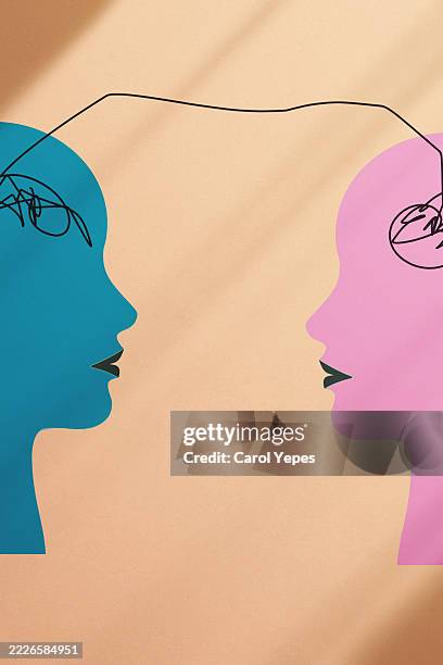 paper cutout figures connected by a single line between them, symbolizing empathy, emotional connection, and mutual understanding. - schriftsymbol stock-fotos und bilder