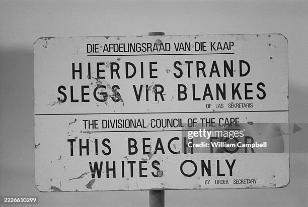 Bilingual apartheid sign declaring 'This beach for Whites Only' on a beach, South Africa, 1 August 1980.