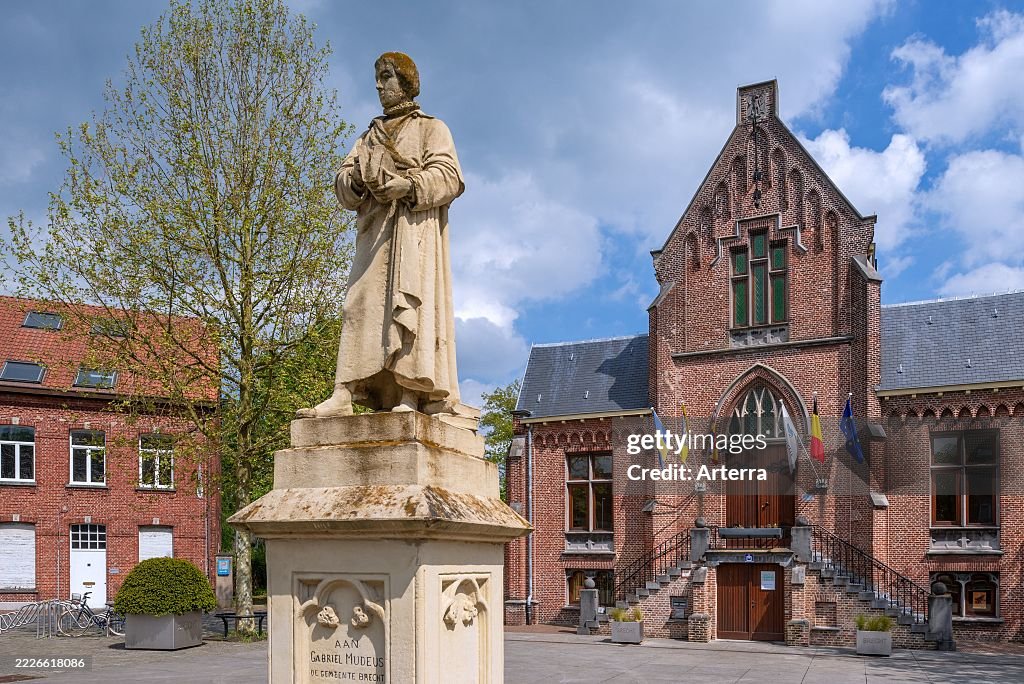 Statue of Gabriel Mudeus on the town square and former city hall in neo-Gothic style in the municipality Brecht.