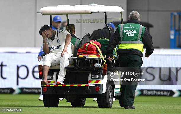 India batsman Rishabh Pant leaves the field on a medical cart after taking a blow to the foot during day one of the Fourth Test Match between England...