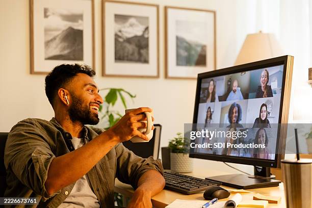 man enjoys video conference call with colleagues, smiling - virtual meet and greet stock pictures, royalty-free photos & images