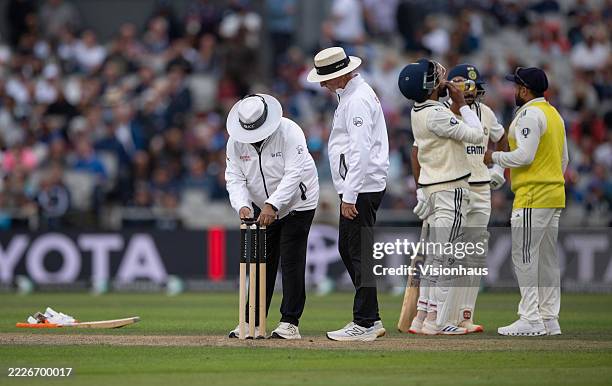 Umpires Ahsan Raza and Rod Tucker take a light meter reading during day one of the fourth Rothesay Test Match between England and India at Emirates...