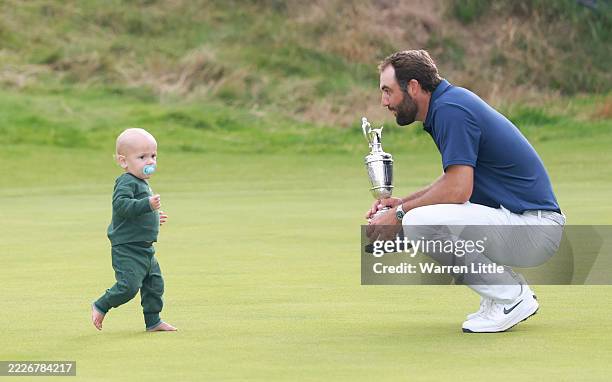 Scottie Scheffler of the United States celebrates with his son Bennett Scheffler and the Claret Jug on the 18th green after winning The 153rd Open...