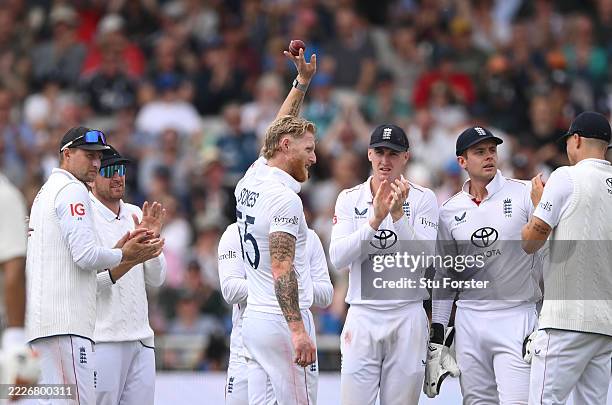 England bowler Ben Stokes holds aloft the ball after taking a five wicket haul during day two of the Fourth Test Match between England and India at...