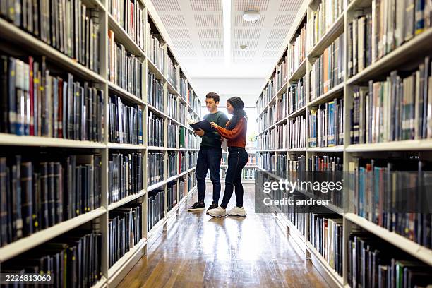 students searching for a book at the library - public library stock pictures, royalty-free photos & images