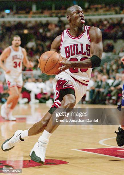 Michael Jordan, Shooting Guard and Small Forward for the Chicago Bulls in motion driving for the basket during the NBA Pre-Season basketball game...