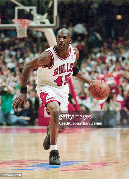 Michael Jordan, Shooting Guard and Small Forward for the Chicago Bulls in motion dribbling the basketball down court during Game 4 of the NBA Eastern...
