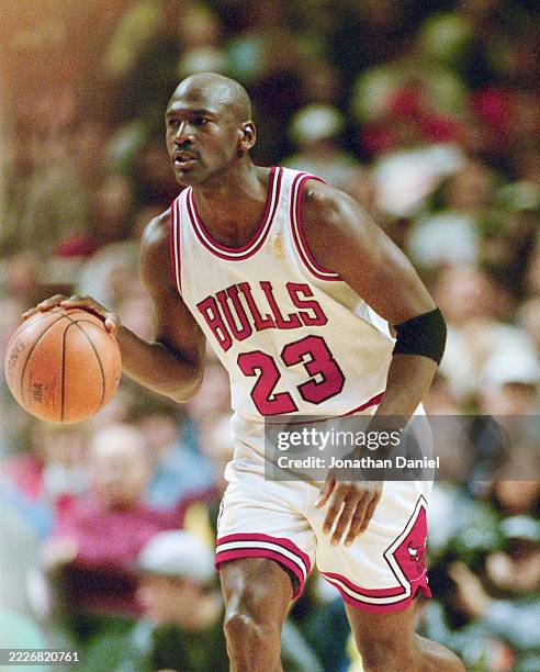 Michael Jordan, Shooting Guard and Small Forward for the Chicago Bulls in motion dribbling the basketball down court during the NBA Central Division...