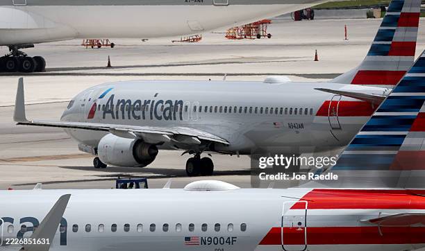 American Airlines planes on the tarmac at the Miami International Airport on July 24, 2025 in Miami, Florida. American Airlines issued a cautious...