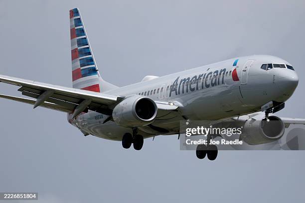 An American Airlines plane lands at the Miami International Airport on July 24, 2025 in Miami, Florida. American Airlines issued a cautious forecast...