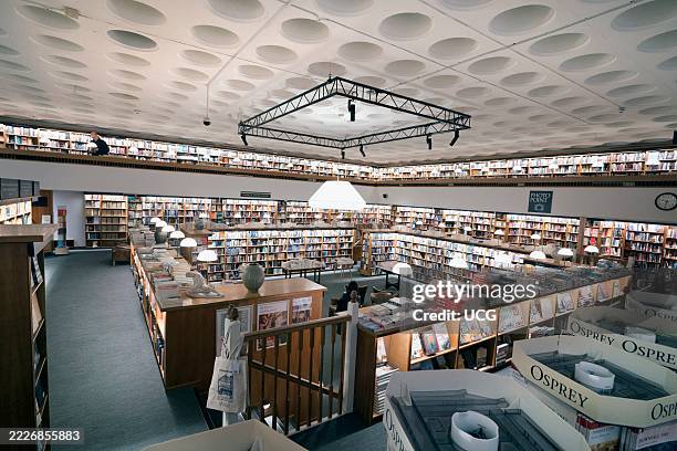 Cavernous underground reading room of Blackwell's bookshop in the historic heart of Oxford at dawn.