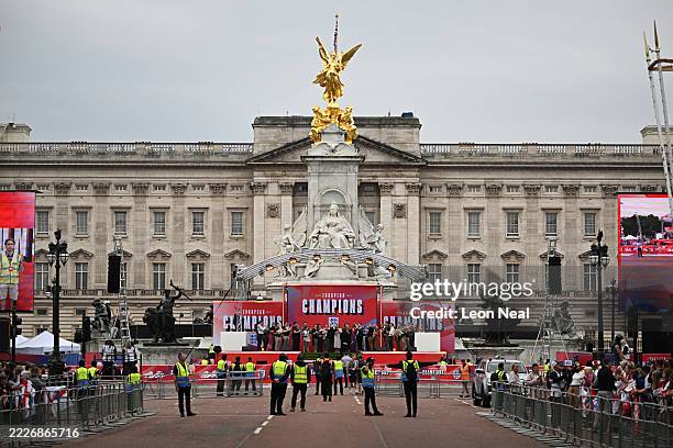 Band rehearses on the stage as people start to line the parade route along The Mall near Buckingham Palace ahead of the England Women's team victory...