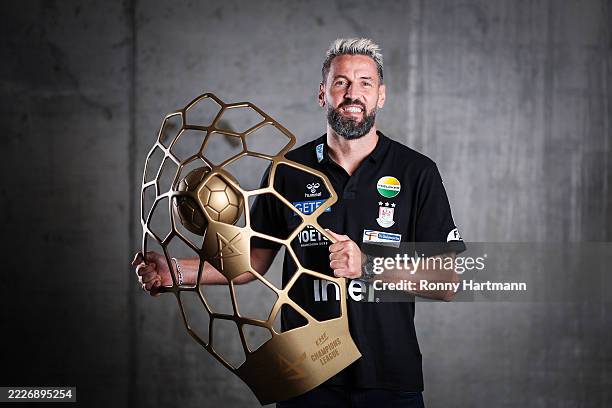 Head coach Bennet Wiegert of SC Magdeburg poses with the trophy for winning the Handball Champions League 2025 during the team presentation at Getec...